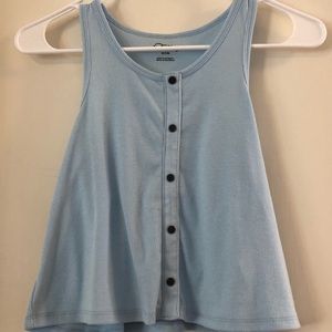 A light blue tank top with black buttons